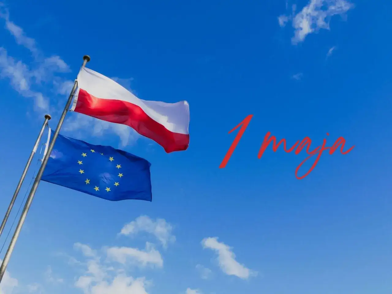 Flagi Polski i UE na tle błękitnego nieba. Czerwony napis
